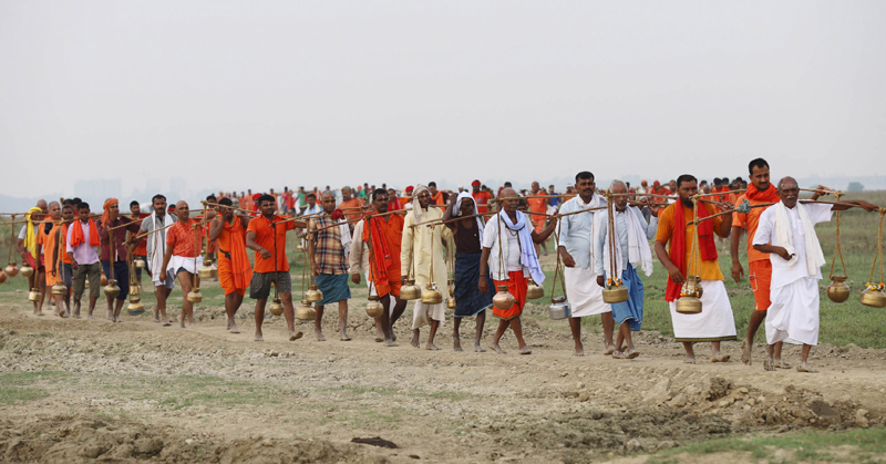 Devotees carrying holy water from the Ganges in Praygraj amid the ongoing Mal Maas