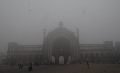 A man cycles in a fog covered morning in Lucknow