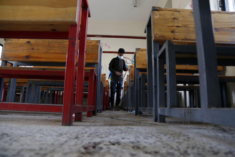 Health worker sanitising classroom in Yemen's capital Sanaa