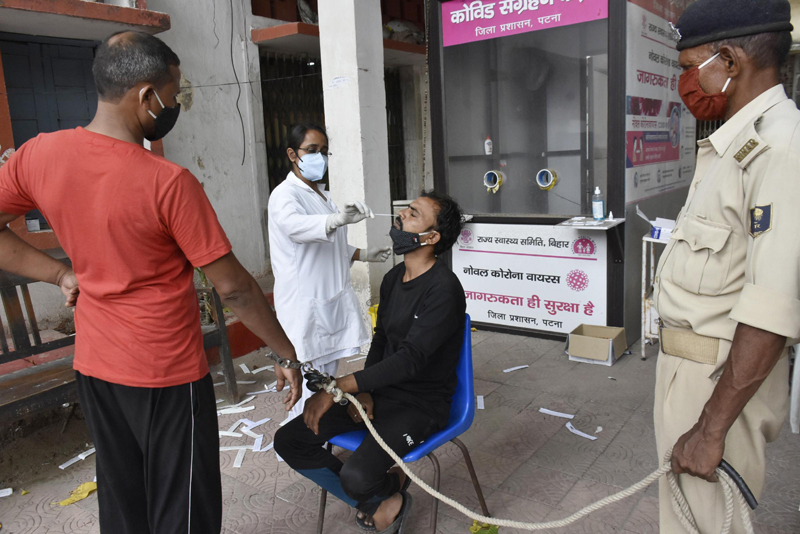 Health worker collects swab of accused before court appearing