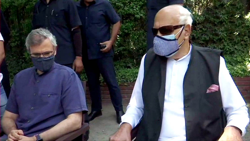 Farooq Abdullah flanked by his son Omar Abdullah during a press conference in Srinagar