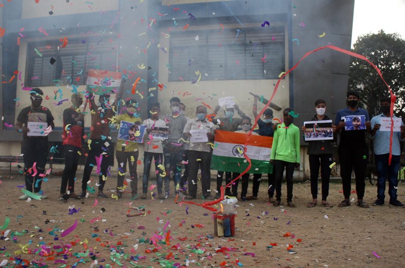 People in India celebrate India's historic win in Australia