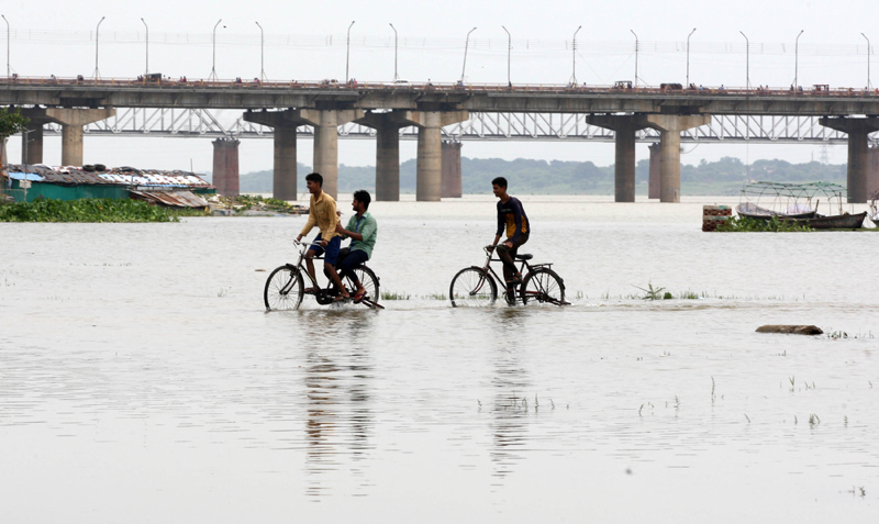 Prayagraj: Boys cycling in the flood water of Ganga