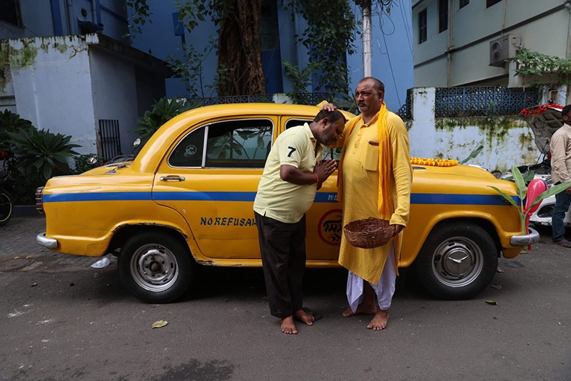 Priest offers prayers to taxi during Vishwakarma Puja in Kolkata