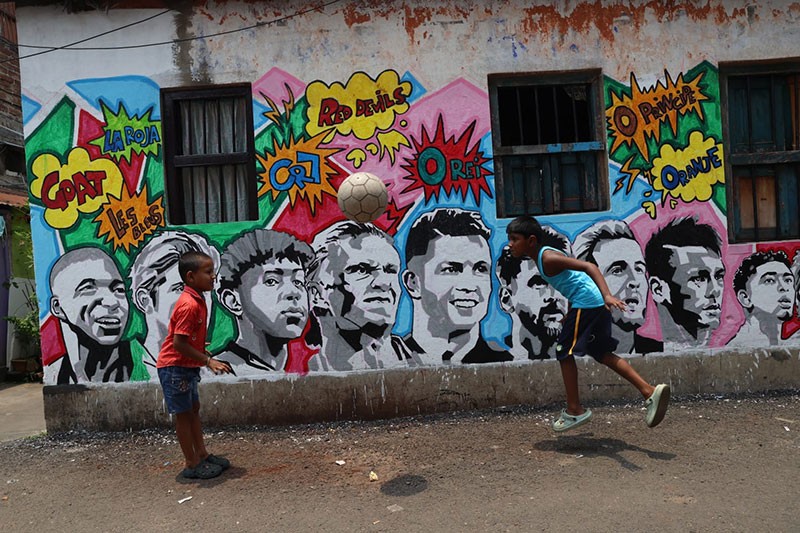 In Images: Children in Kolkata play beneath a giant World Cup masterpiece