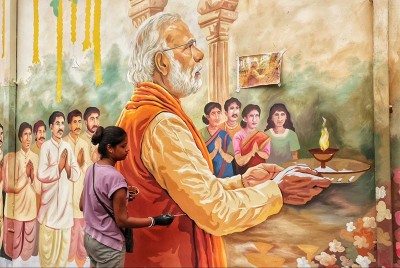 In Images: Kolkata’s Chorebagan Sarbojonin unveils wall painting of PM Modi performing aarti to Goddess Durga