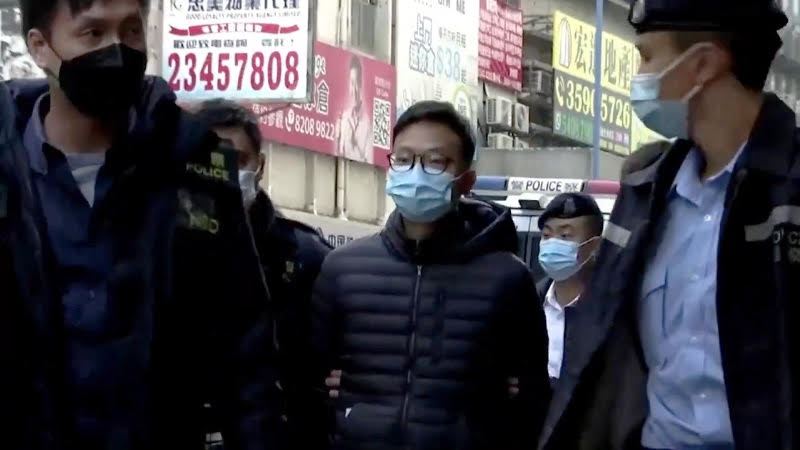Stand News Acting Chief Editor Patrick Lam is escorted by police following his arrest on Wednesday (Dec 29). Image: Screengrab from Youtube video by Crannofonix. 