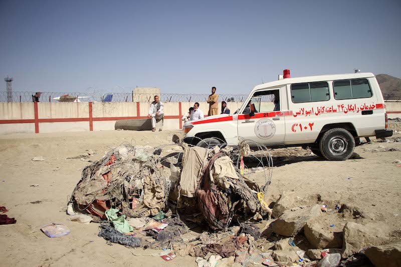 An ambulance is seen at the explosion site near the Kabul airport in Afghanistan, Aug. 27, 2021. The death toll from the Kabul airport attacks on Thursday has reportedly risen to at least 103 /UNI.