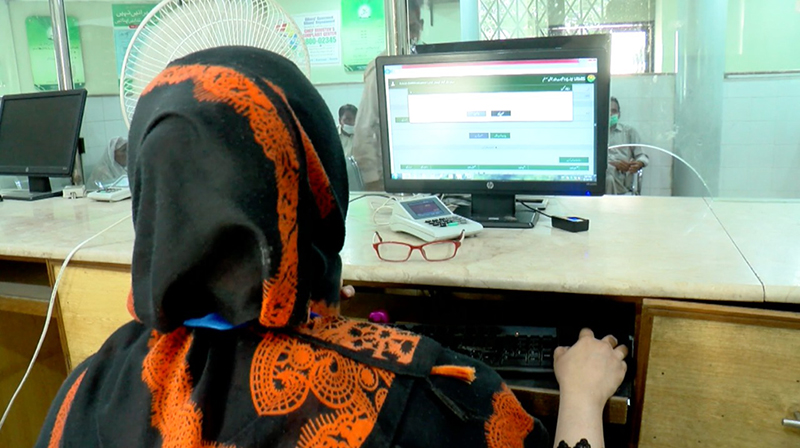 A government servant at the land records station in Lahore, Pakistan, looks up digital records. Pakistan and India both are working to digitise land records to make them easier to access and reduce disputes and corruption. (Shiraz Hasnat)