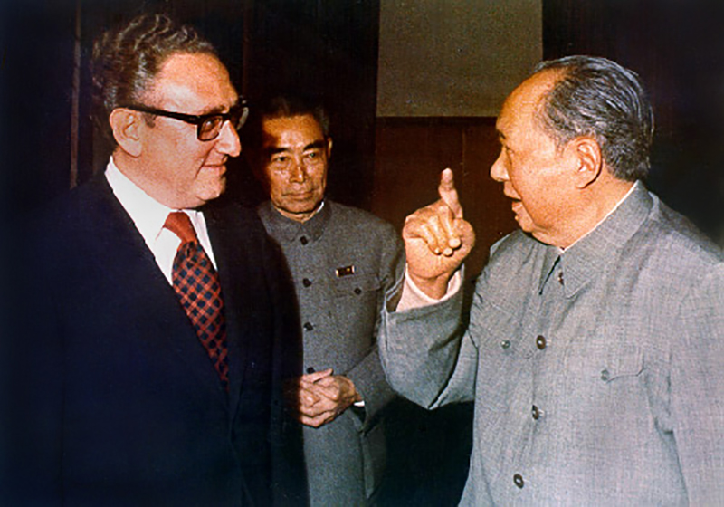 Kissinger, shown here with Zhou Enlai and Mao Zedong, negotiated rapprochement with China.